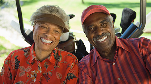 Happy black couple riding on a golf cart photo